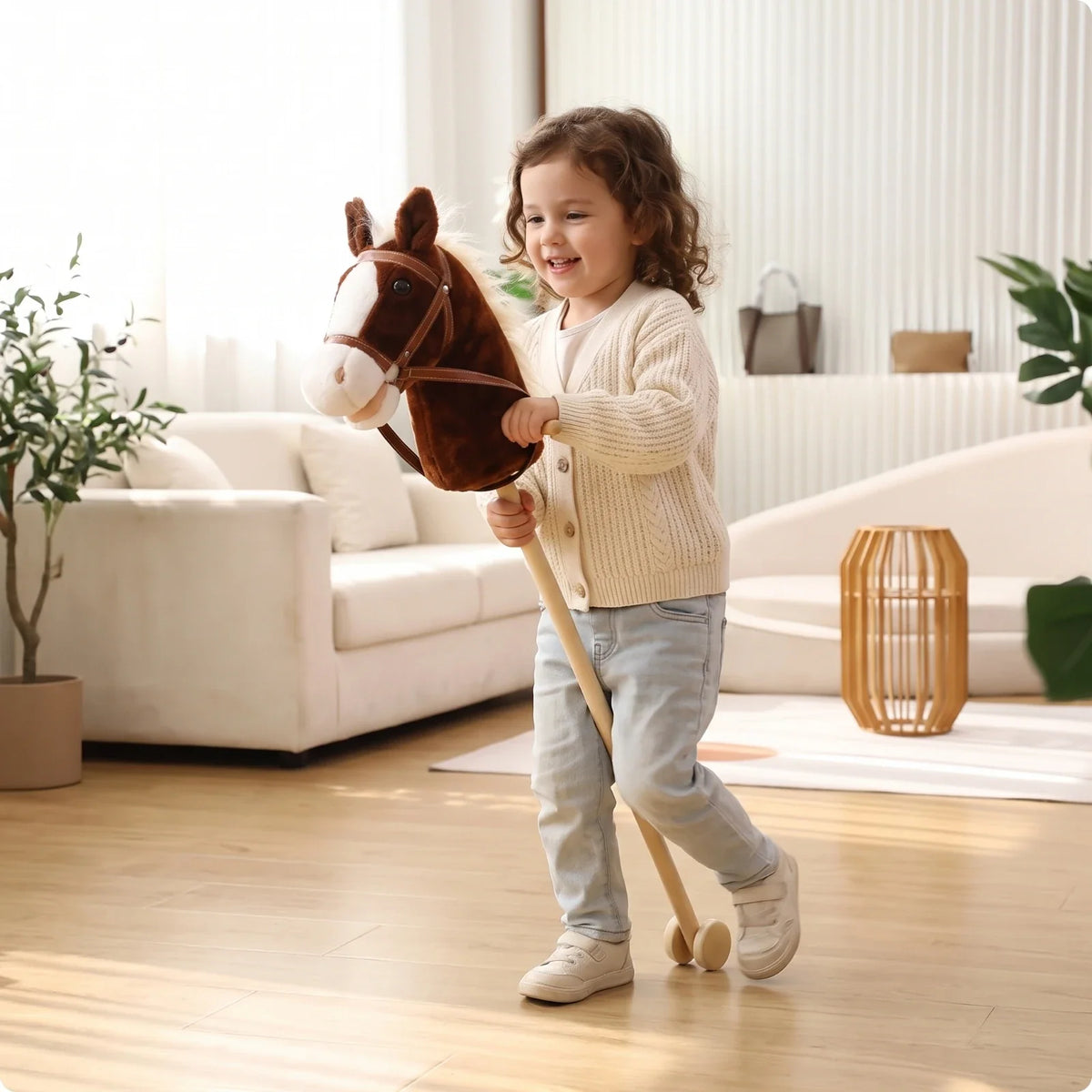 Toddler playing with a dark brown plush stick horse toy on wooden wheels