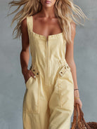 Light yellow denim jumpsuit for women with square neckline and zip-front closure, by Christine Brewer.