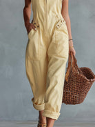 Light yellow denim jumpsuit for women with square neckline and zip-front, by Christine Brewer, featuring stylish pant silhouette.
