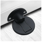 Black door stopper on a white floor