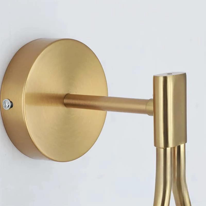 Nordic Brass Wall Light mounted on a wall with a round brass backplate.