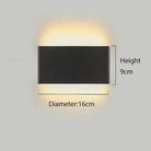 Minimalist aluminium LED wall light; black finish with upward and downward glow on a bedroom wall.