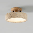 Ceiling light fixture with wooden top and beige stone-like base on a gray background