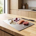 Premium Stainless Steel Chopping Board by Nordic Essentials on a kitchen island; silver, double-sided and knife-safe.