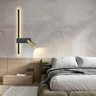 SVEA – Swivel LED Wall Light; wall-mounted black and brass reading lamp above a bedroom bed.