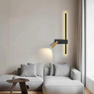 Swivel LED Wall Light with vertical black strip and brass adjustable head on living room wall beside sofa
