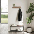 Wood and iron coat rack with hidden hooks and shelf mounted in a modern entryway beside a bench.