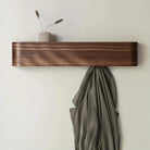 Wood & Iron Coat Rack in dark wood finish mounted on an entryway wall with hidden hooks and shelf.