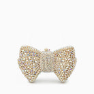 Elegant clutch bag in soft leather with a sleek silhouette, featuring gold tone clasp and detachable chain strap