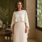 long wedding guest dress — Beige wedding guest dress boat neckline cape and pleat detail — view 6