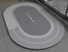 Super Absorbent Non-Slip Bath Mat gray color on bathroom floor 